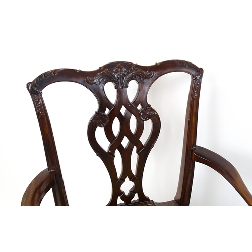 1861 - A pair of late 19thC Chippendale style open armchairs, with pierced and carved back splats above spl... 