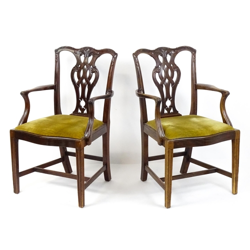 1861 - A pair of late 19thC Chippendale style open armchairs, with pierced and carved back splats above spl... 