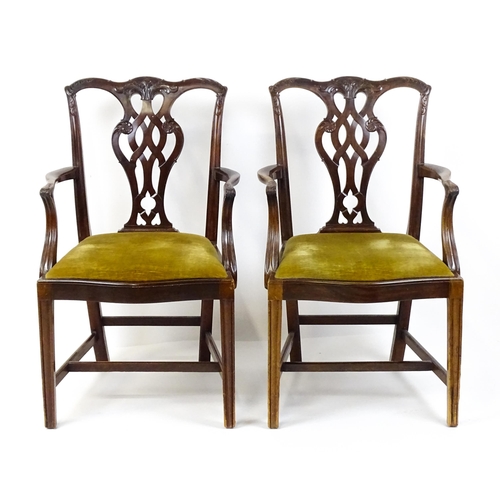 1861 - A pair of late 19thC Chippendale style open armchairs, with pierced and carved back splats above spl... 