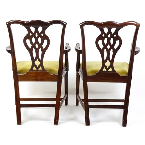 1861 - A pair of late 19thC Chippendale style open armchairs, with pierced and carved back splats above spl... 