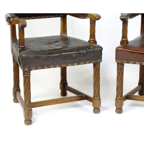 1863 - A pair of late 19thC / early 20thC leather upholstered armchairs with swept arms and brass detailing... 