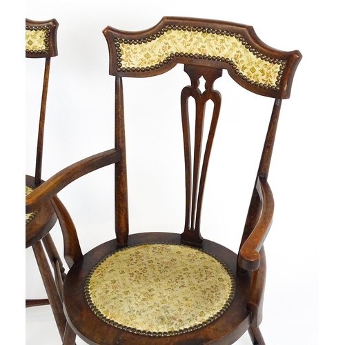 1864 - A set of four Arts & Crafts chairs with shaped and upholstered backrests above pierced back splats a... 