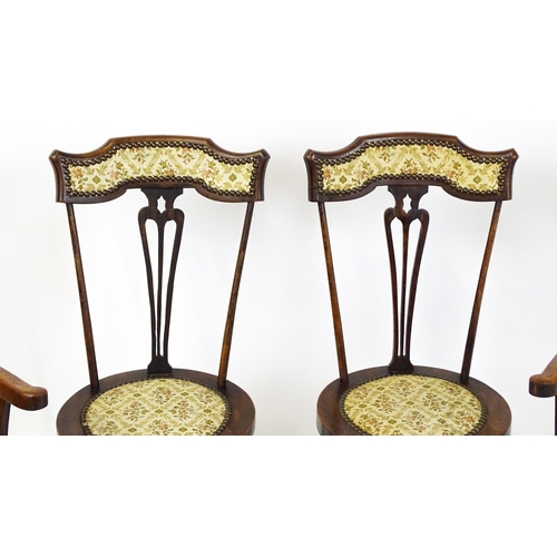 1864 - A set of four Arts & Crafts chairs with shaped and upholstered backrests above pierced back splats a... 