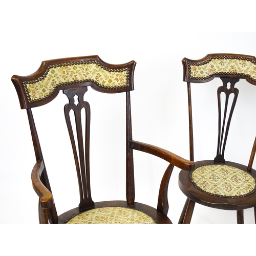 1864 - A set of four Arts & Crafts chairs with shaped and upholstered backrests above pierced back splats a... 