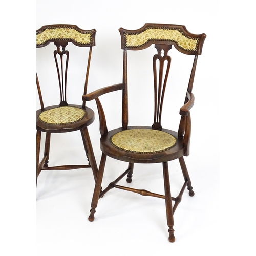 1864 - A set of four Arts & Crafts chairs with shaped and upholstered backrests above pierced back splats a... 