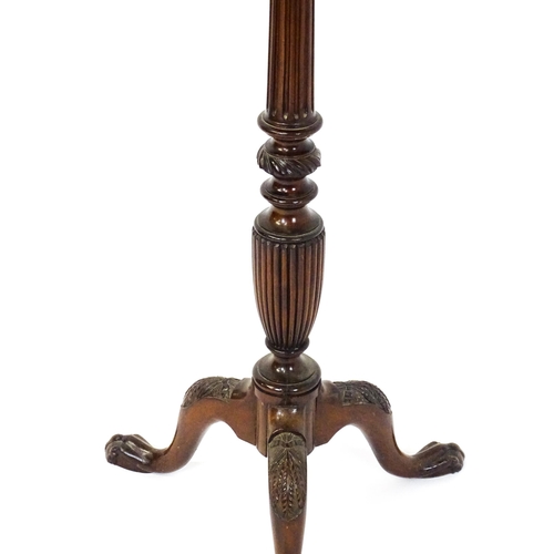 1872 - A 19thC mahogany jardinière stand with a circular top above a fluted, reeded and carved pedestal rai... 