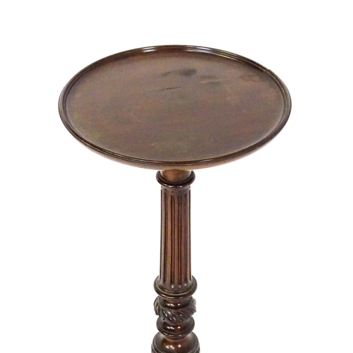 1872 - A 19thC mahogany jardinière stand with a circular top above a fluted, reeded and carved pedestal rai... 