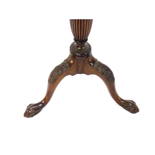 1872 - A 19thC mahogany jardinière stand with a circular top above a fluted, reeded and carved pedestal rai... 