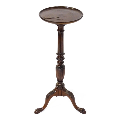 1872 - A 19thC mahogany jardinière stand with a circular top above a fluted, reeded and carved pedestal rai... 