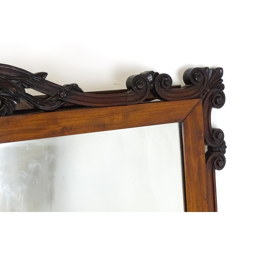 1873 - A large late 19thC mahogany over mantle mirror with a carved scrolling pediment. 60