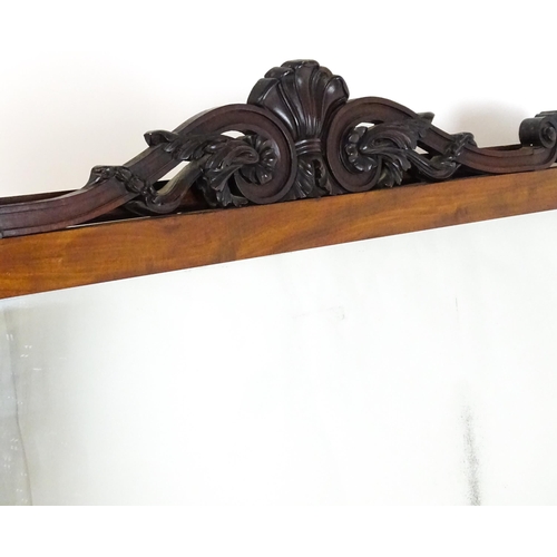 1873 - A large late 19thC mahogany over mantle mirror with a carved scrolling pediment. 60