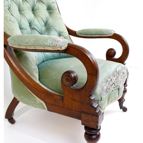 1899 - A Victorian mahogany armchair with a scrolled and deep buttoned backrest above manchettes and a spru... 