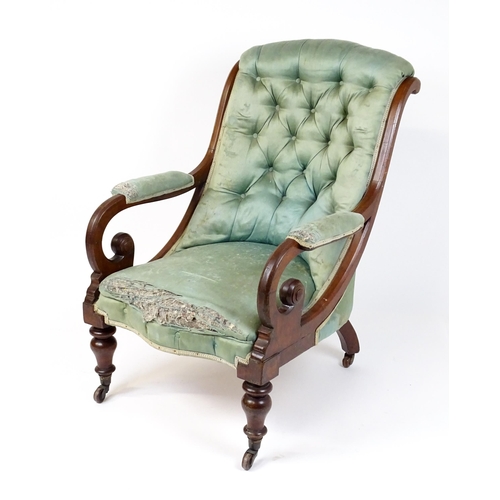 1899 - A Victorian mahogany armchair with a scrolled and deep buttoned backrest above manchettes and a spru... 