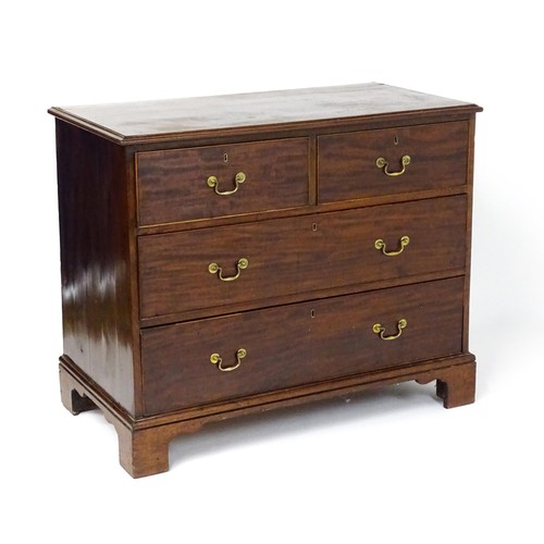 1736 - A Georgian mahogany chest of drawers with a moulded top above two short over two long drawers with s... 