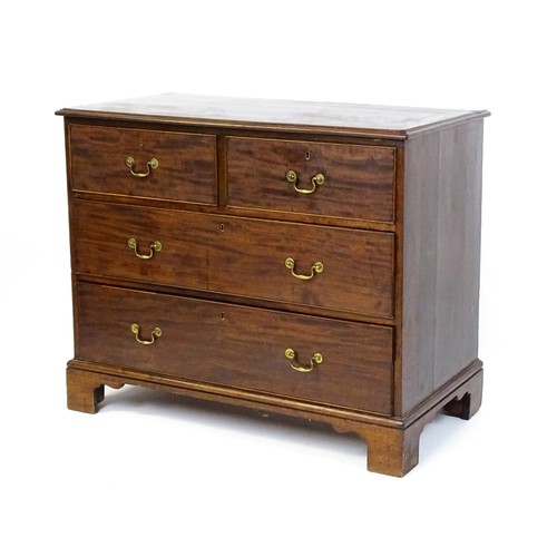 1736 - A Georgian mahogany chest of drawers with a moulded top above two short over two long drawers with s... 