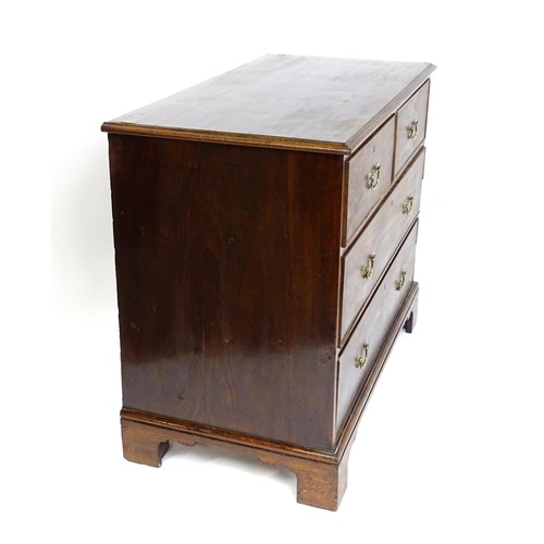 1736 - A Georgian mahogany chest of drawers with a moulded top above two short over two long drawers with s... 