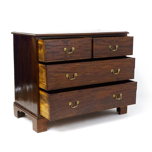 1736 - A Georgian mahogany chest of drawers with a moulded top above two short over two long drawers with s... 