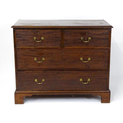 1736 - A Georgian mahogany chest of drawers with a moulded top above two short over two long drawers with s... 