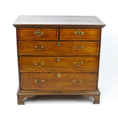 1752 - An 18thC oak chest of drawers with a moulded top above two short over three long drawers with crossb... 