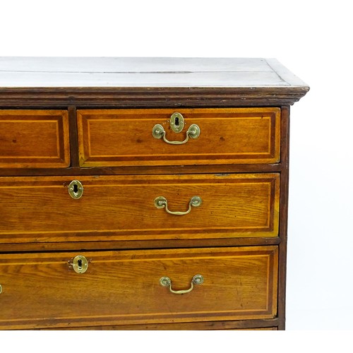 1752 - An 18thC oak chest of drawers with a moulded top above two short over three long drawers with crossb... 