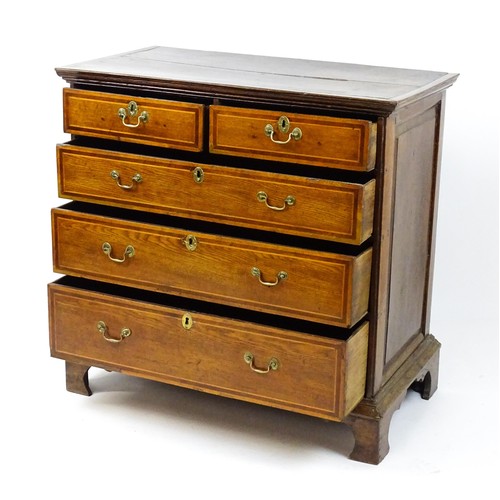 1752 - An 18thC oak chest of drawers with a moulded top above two short over three long drawers with crossb... 