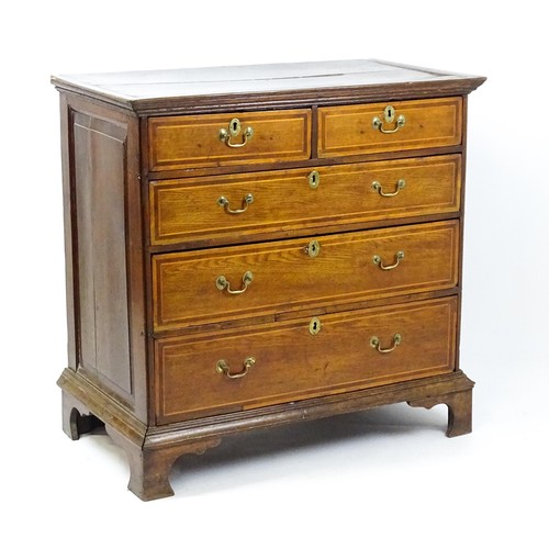 1752 - An 18thC oak chest of drawers with a moulded top above two short over three long drawers with crossb... 