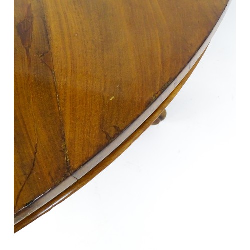 1895 - A Victorian mahogany breakfast / dining table with a round tilt op above a turned pedestal raised on... 