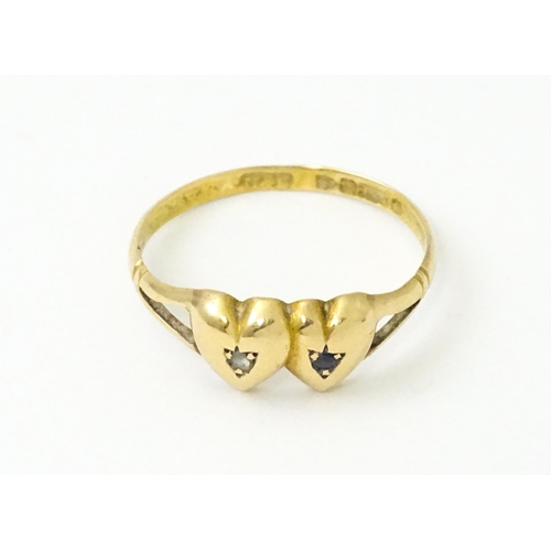 839 - A Victorian 15ct gold ring set with twin heart detail set with diamond and sapphire. Hallmarked Ches... 