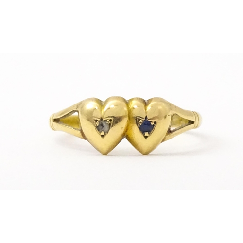 839 - A Victorian 15ct gold ring set with twin heart detail set with diamond and sapphire. Hallmarked Ches... 