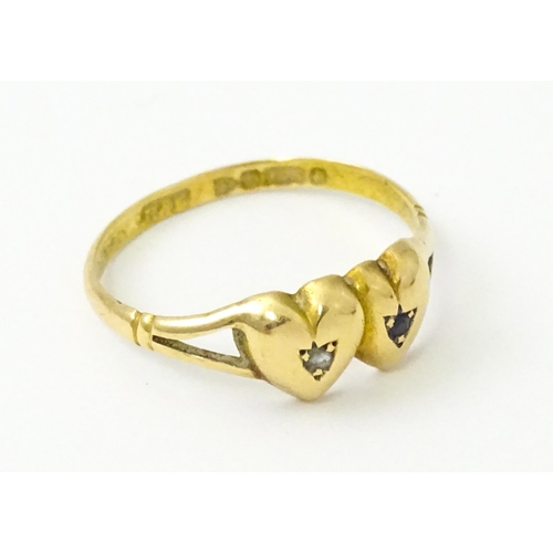 839 - A Victorian 15ct gold ring set with twin heart detail set with diamond and sapphire. Hallmarked Ches... 