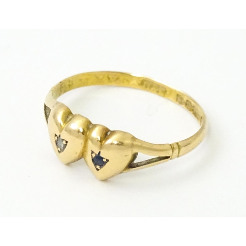 839 - A Victorian 15ct gold ring set with twin heart detail set with diamond and sapphire. Hallmarked Ches... 