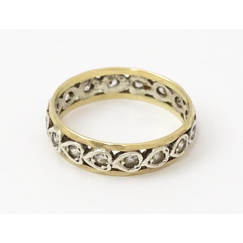 857 - A 9ct gold ring set with white stones and heart shaped detail. Ring size approx. M