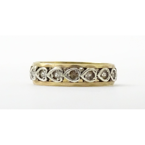 857 - A 9ct gold ring set with white stones and heart shaped detail. Ring size approx. M