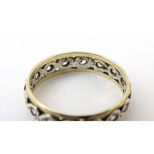 857 - A 9ct gold ring set with white stones and heart shaped detail. Ring size approx. M