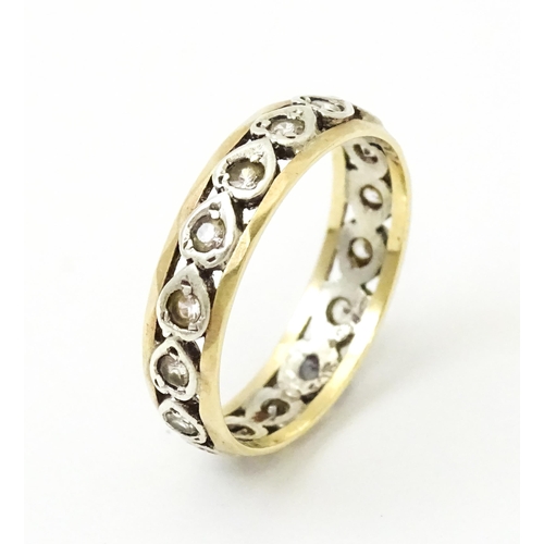 857 - A 9ct gold ring set with white stones and heart shaped detail. Ring size approx. M