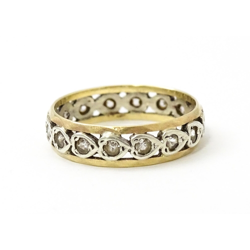 857 - A 9ct gold ring set with white stones and heart shaped detail. Ring size approx. M