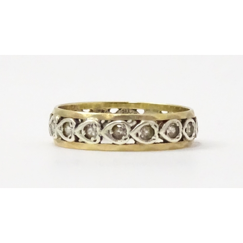 857 - A 9ct gold ring set with white stones and heart shaped detail. Ring size approx. M