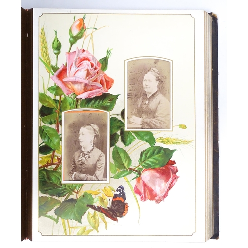 2462 - A Victorian leather covered Album des Roses photograph album by Marcus Ward & Co. containing various... 