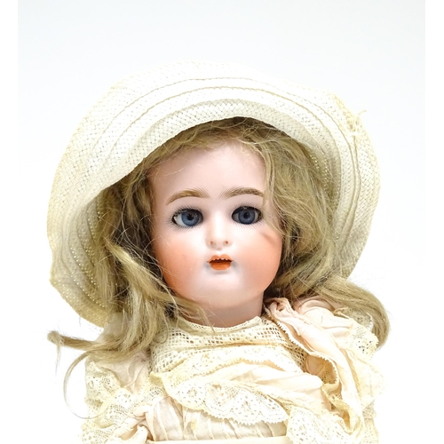 1172 - Toy: A German Kammer & Reinhardt doll with bisque head, blinking eyes, painted lips and eyebrows, wi... 