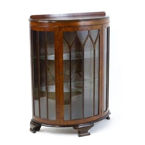 1735 - An early / mid 20thC walnut display cabinet with an upstand above an astragal glazed door raised on ... 