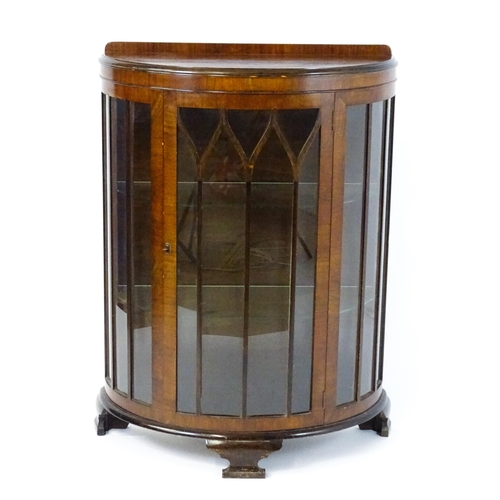 1735 - An early / mid 20thC walnut display cabinet with an upstand above an astragal glazed door raised on ... 