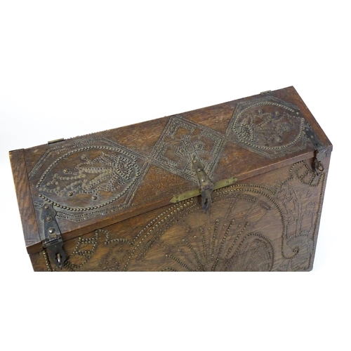 1751 - A large late 19thC Anglo-Indian oak casket / dowry chest with brass stud detailing depicting peacock... 