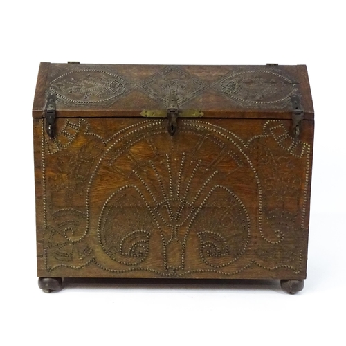 1751 - A large late 19thC Anglo-Indian oak casket / dowry chest with brass stud detailing depicting peacock... 