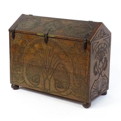 1751 - A large late 19thC Anglo-Indian oak casket / dowry chest with brass stud detailing depicting peacock... 