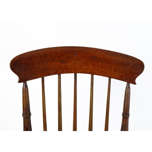 1868 - A late 19thC stick back Windsor chair with swept arms, a shaped elm seat and raised on four turned t... 