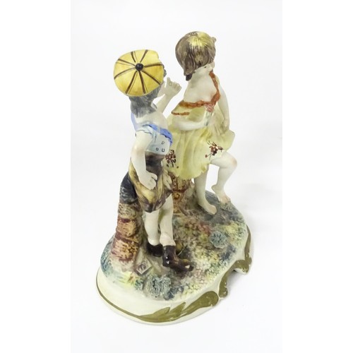 778 - A Capodimonte figural group depicting a boy and girl dancing. Approx. 10 1/2