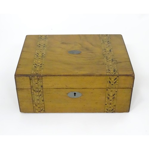 788 - A 19thC walnut work box with decorative inlaid bands in the style of Tunbridgeware, containing a qua... 