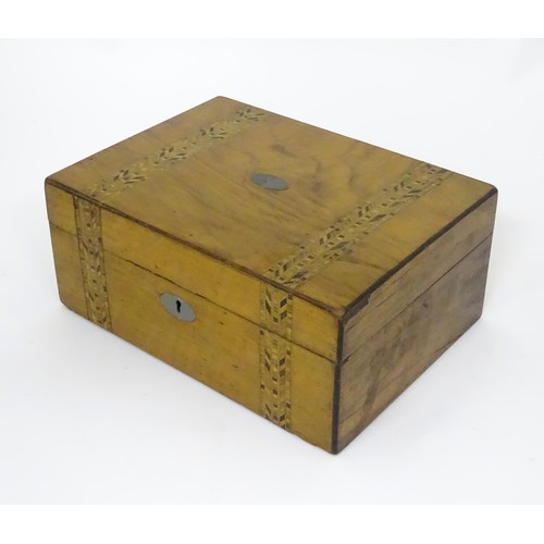 788 - A 19thC walnut work box with decorative inlaid bands in the style of Tunbridgeware, containing a qua... 