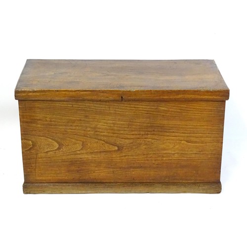 842 - An early to mid 20thC elm trunk with cast handles and paper lined interior. Approx 38