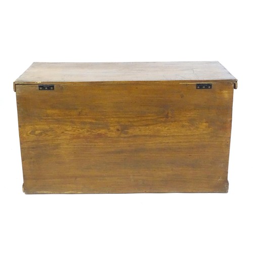 842 - An early to mid 20thC elm trunk with cast handles and paper lined interior. Approx 38